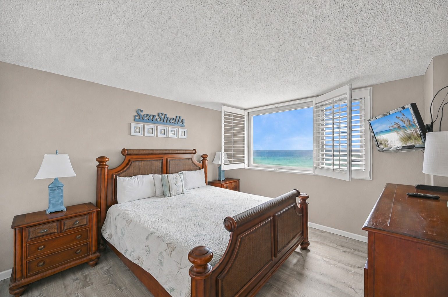 Master bedroom with a king bed and an open window onto the Gulf