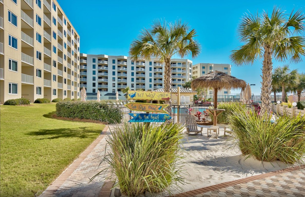 Palm-lined path past the pool to the beach